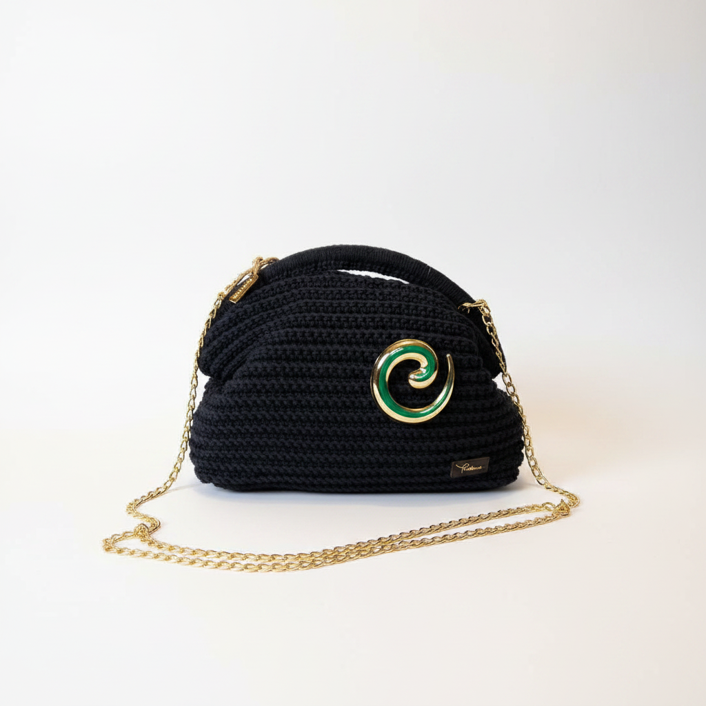 Black crochet dome bag with gold chain strap and swirl brooch